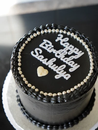 Bold celebration black cake with modern design in Peterborough
