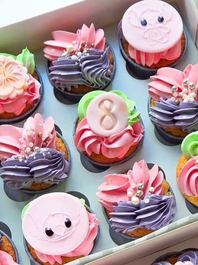 Colourful birthday cupcakes with pink, purple and neon buttercream swirls