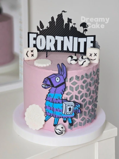 Fortnite themed birthday cake with llama topper and gaming decorations