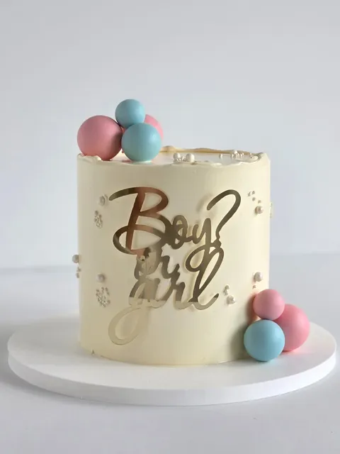Cream celebration cake with Boy or Girl topper and pastel balloons