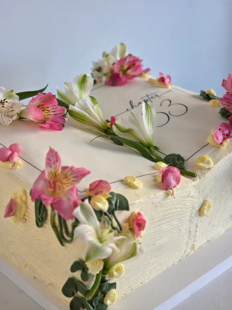 Rectangular 33rd birthday cake decorated with fresh pink and white flowers