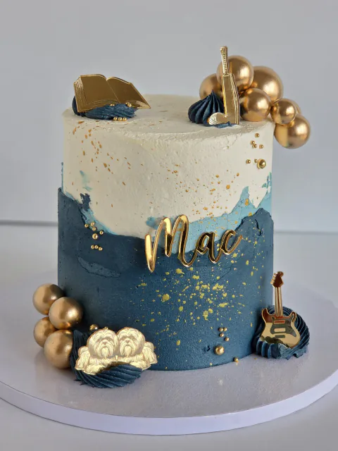 Navy and cream music-themed cake for Mac with guitars, book and gold spheres