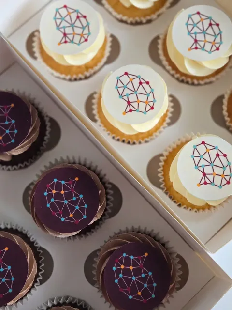 Cupcakes with custom printed toppers featuring a network graphic