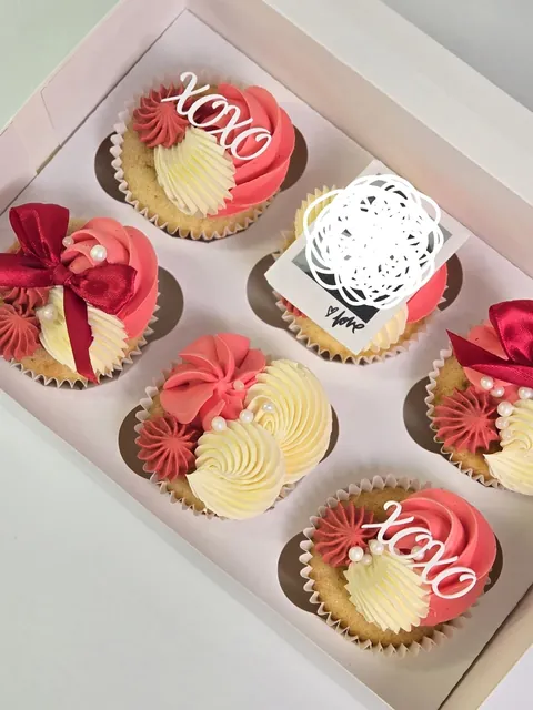 Cupcake box with red bows, XOXO toppers and a small photo topper