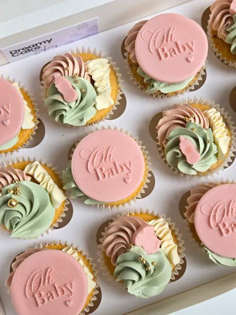 Pastel Oh Baby cupcakes for a baby shower in pink, green and cream