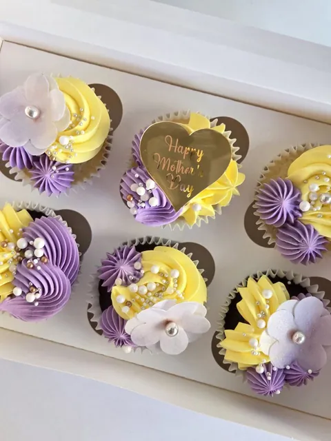 Close-up of Mother’s Day cupcakes with floral details and topper