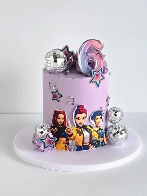 Lilac themed birthday cake with cartoon toppers, disco balls and stars