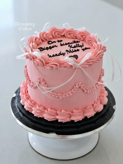 Pink vintage message cake with piped borders and personalised writing