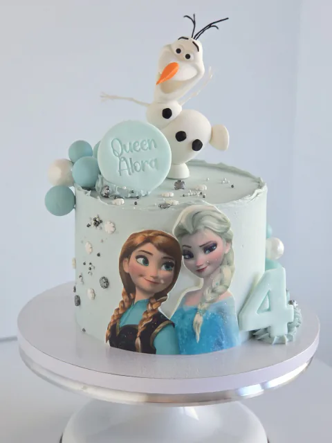 Frozen-themed birthday cake with Elsa, Olaf and icy blue decorations