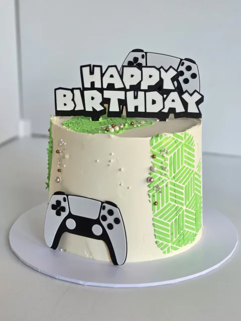 Gaming-themed birthday cake with controller, headset and console details