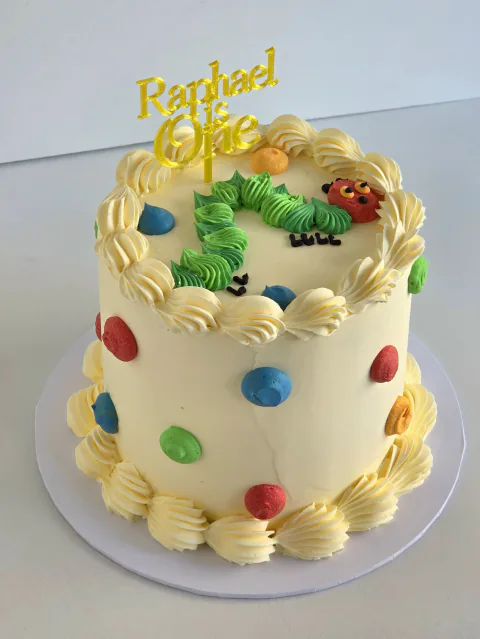 Very Hungry Caterpillar-inspired first birthday cake personalised for Raphael