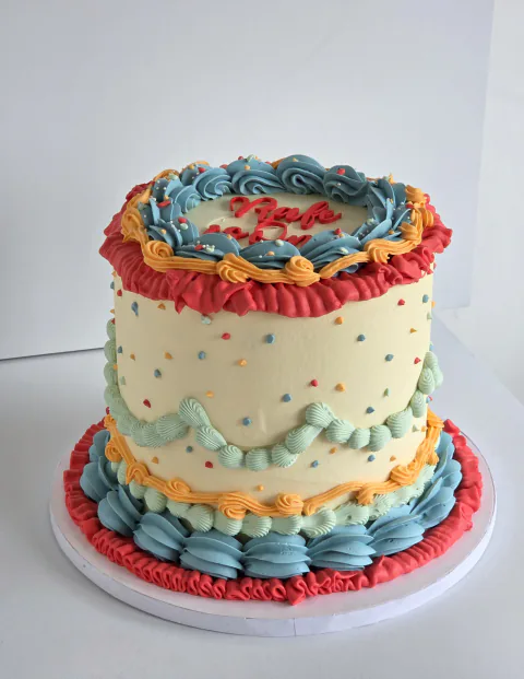Retro celebration cake with colourful vintage buttercream piping