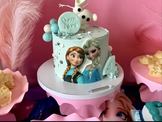 Frozen-themed birthday cake in a customer party setting